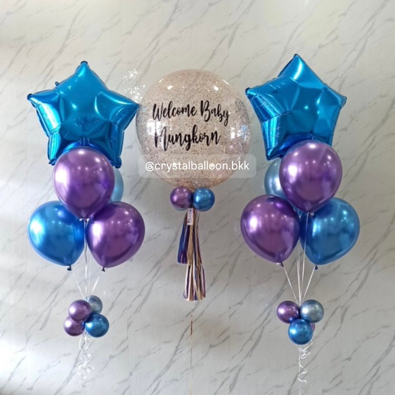 ลูกโป่ง Welcome Baby Bubble ขนาด 24" กลิตเตอร์สีแชมเปญ 1 ลูก พร้อม ช่อลูกโป่งฟอยล์ดาว ขนาด 24" ช่อ 5 ลูก 2 ช่อ Theme น้ำเงินโครเมี่ยม-ม่วงโครเมี่ยม พร้อมตกแต่ง สามารถเปลี่ยนสีลูกโป่ง/เปลี่ยนข้อความ/เปลี่ยนขนาด/เปลี่ยนฟอยล์ตกแต่งได้