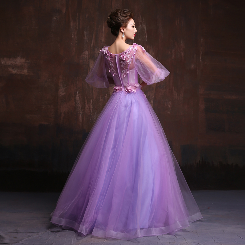 พร้อมเช่า ชุดแฟนซียาว แบบแขนยาว จั๊มปลายแขนน่ารักมาก เนื้อผ้าเป็นตาข่ายแบบซีทรู แต่งดอกและลูกปัด สีม่วง (ซิปหลัง)