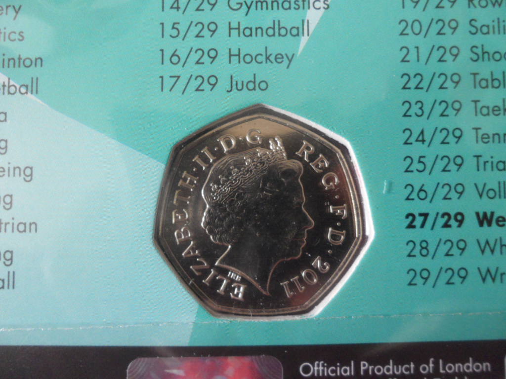 เหรียญที่ระลึก การแข่งขันกีฬาโอลิมปิก - โอลิมปิก ลอนดอน 2012; THE ROYAL MINT ชนิด 50 เพนซ์ ลายยกน้ำหนัก ใหม่ / OLYMPICS International Sports Tournament Souvenir Coin - OLYMPICS LONDON 2012; THE ROYAL MINT 50 Pence WEIGHTLIFTING NEW